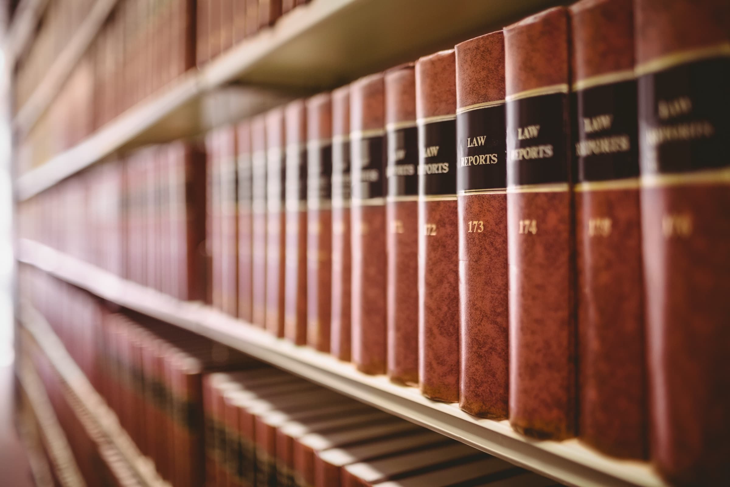 A close-up shelf of bound law reports, numbered volume after volume